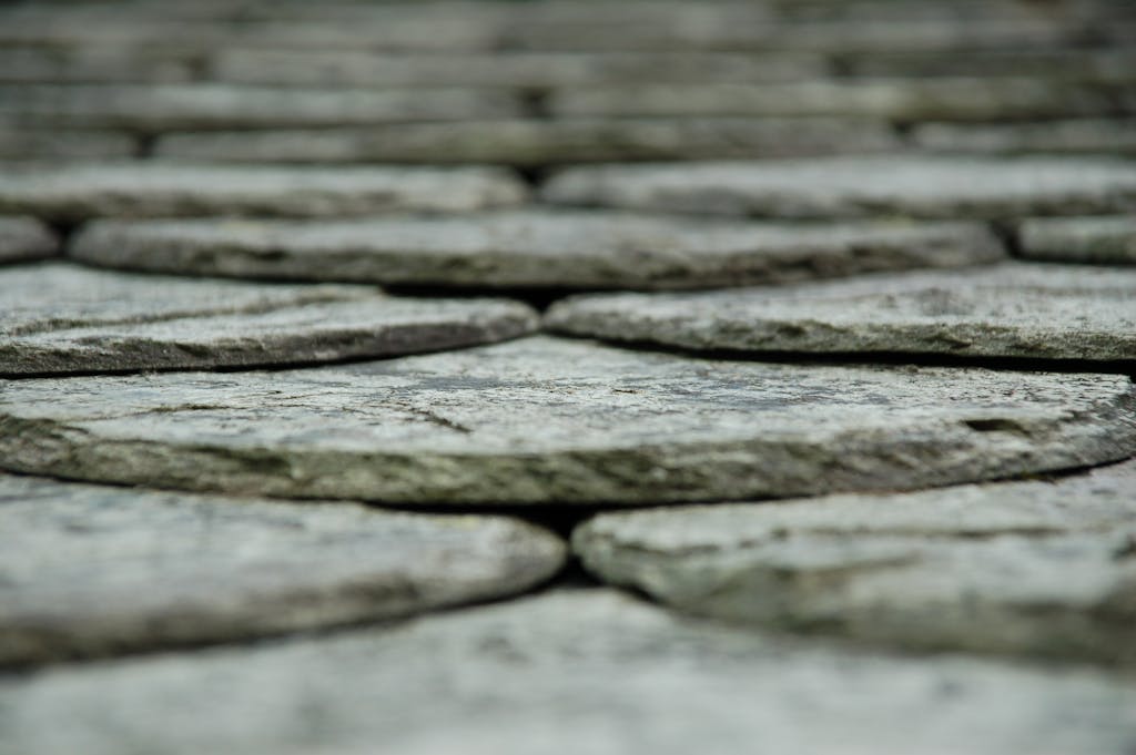 Detailed close-up of textured stone cobblestones, showcasing design and rough surface.